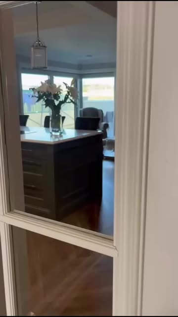 A glimpse through glazed doors into the Shell and Willow kitchen