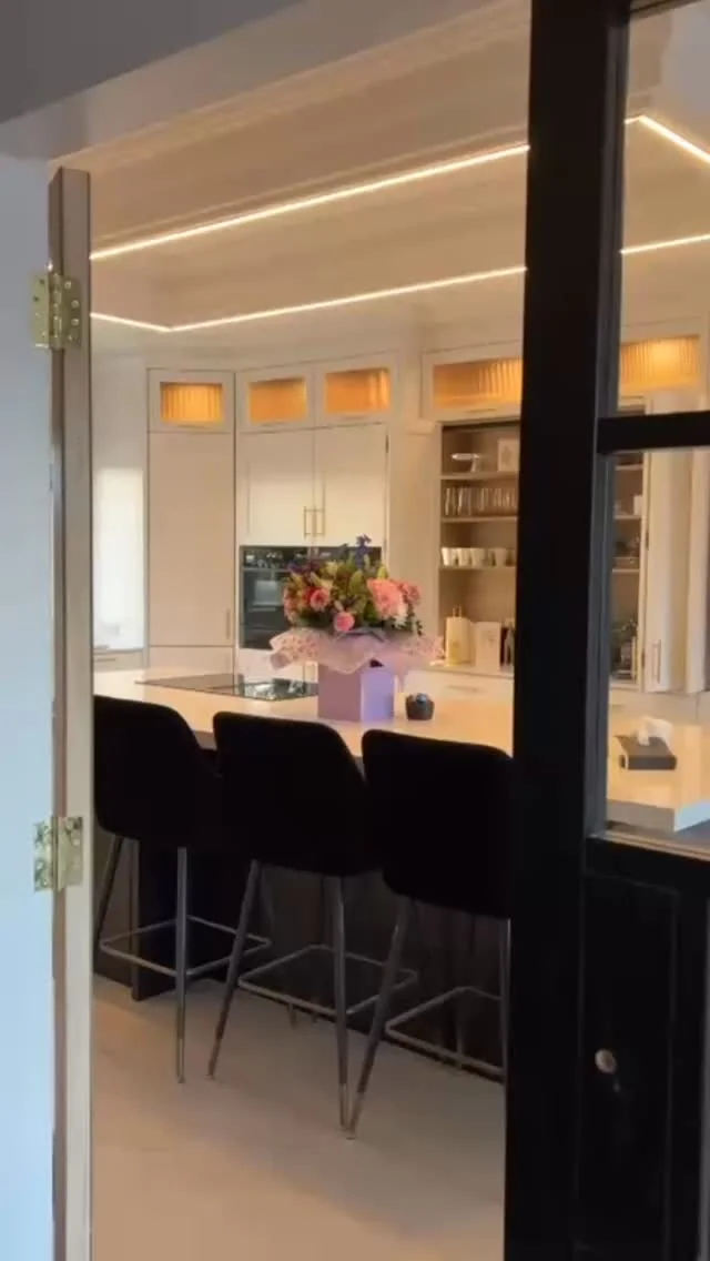 White cabinetry and a dark island in the Blanc Noir kitchen in Buncrana