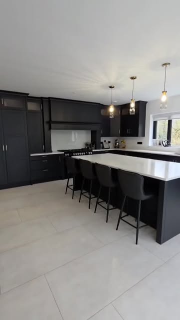 Dark Shaker cabinetry and a quartz island in a Ballybofey kitchen