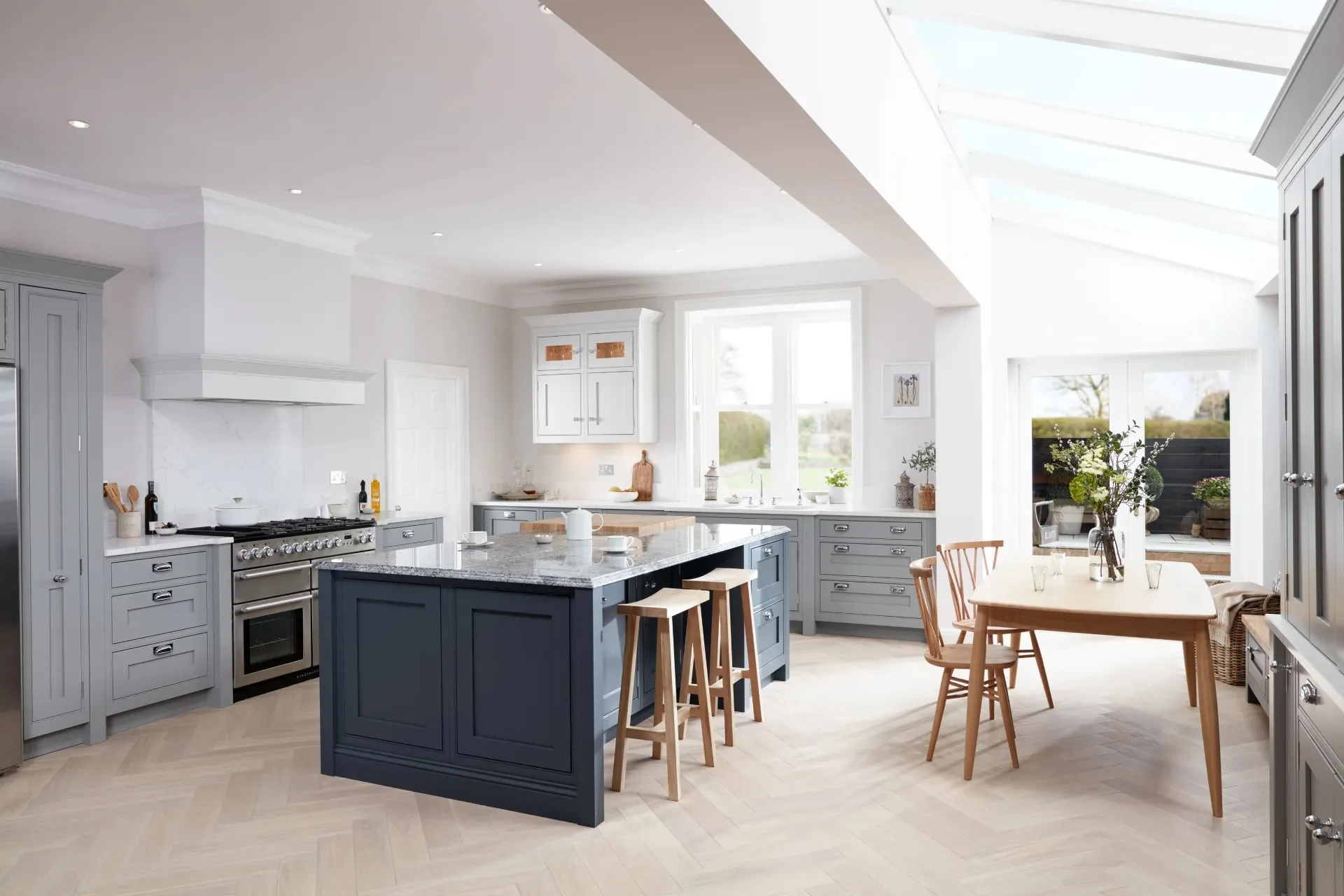 Blue & pale grey: Classic in-frame cabinetry with a blue island. Illustrated palette; confirm finish names with your designer.